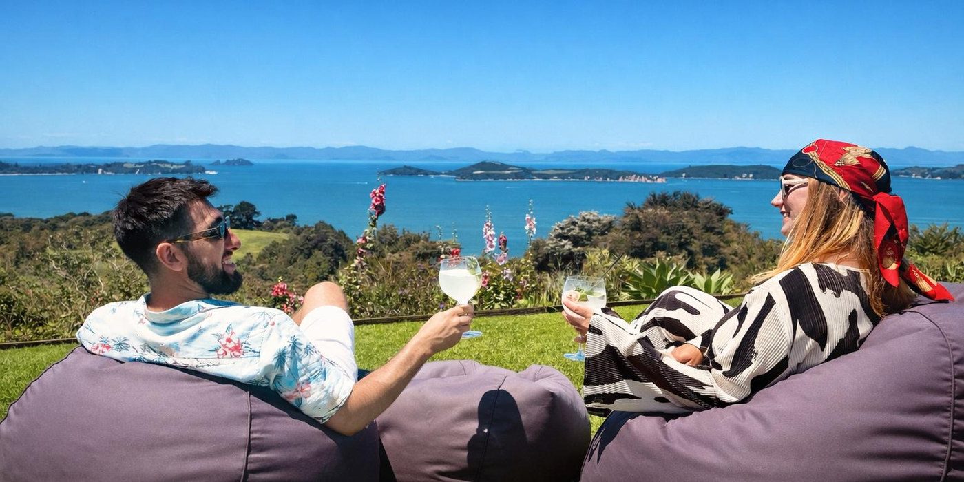 Guests relaxing with wine above the Hauraki Gulf