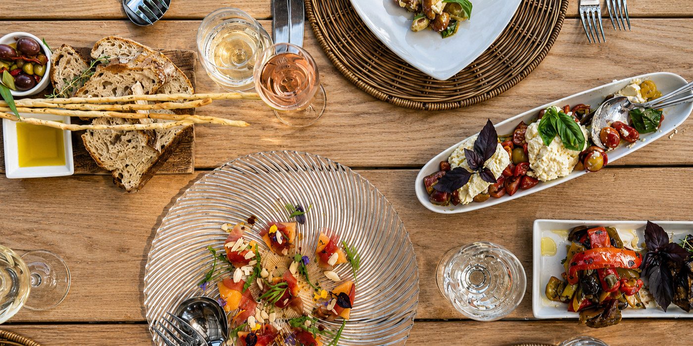 Italian sharing plates and wine laid out for a long lunch